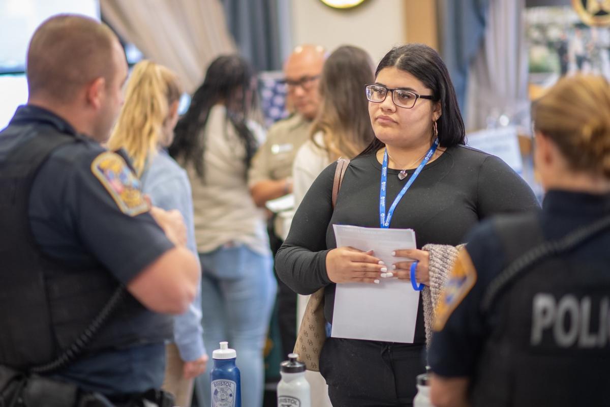 Psychology graduate student speaking with police officers.