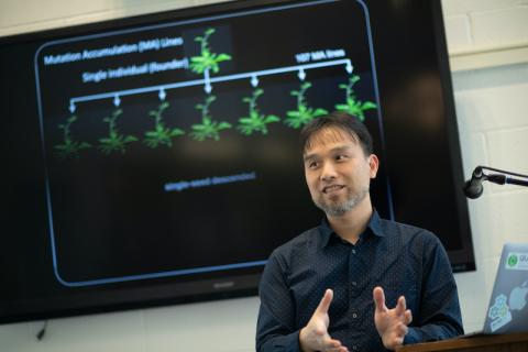 Dr. Weng in front of a TV presenting his research.