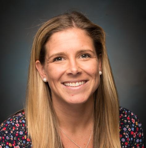 Dr. Lyndsey Nunes, Director of Inclusive Postsecondary Education at Westfield State University. It's a headshot, featuring a gray background behind her.