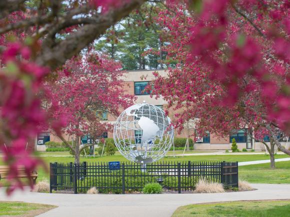 The WSU Globe surrounded by spring blossoms on the campus green