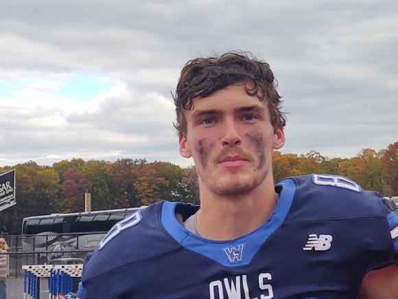Will Brewster, a junior and football player at Westfield State. He's wearing his Owls uniform and has dark paint smudged on his face from a recent game.