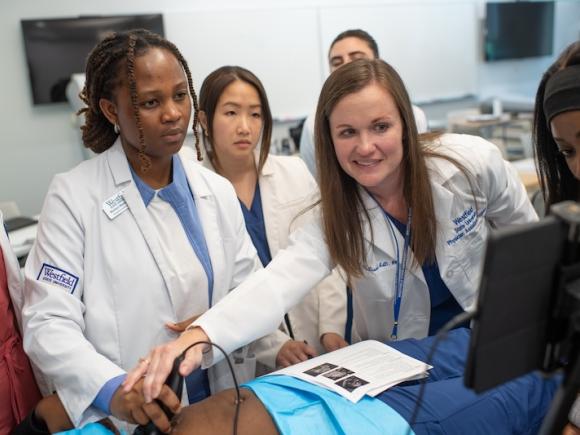 Dr. Susan McDiarmid, Assistant Director of the Physician Assistant Program & Director of Clinical Education, teaching students how to use new butterfly ultrasound machines in a class workshop.