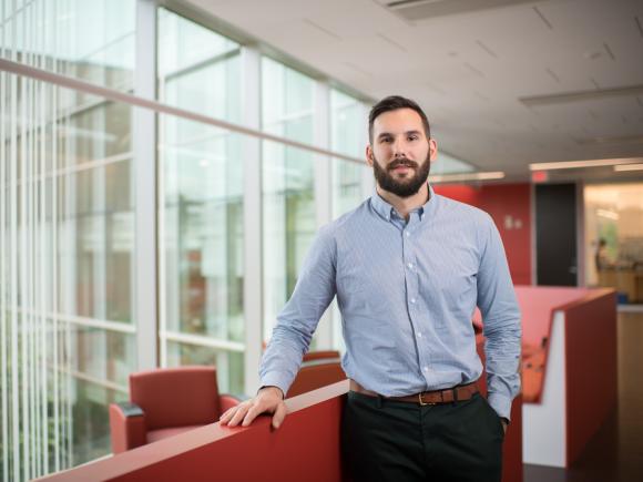Smiling nursing student standing in the Nettie Stevens Science Center at Westfield State University.