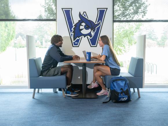 Two students studying together in the campus center.