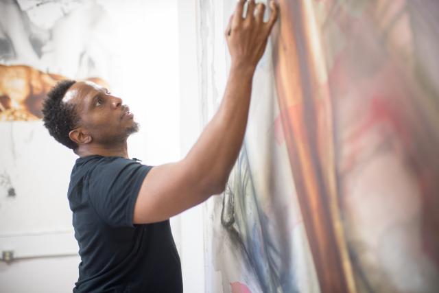 Art professor, Imo Imeh, working on one of his large canvases in his studio
