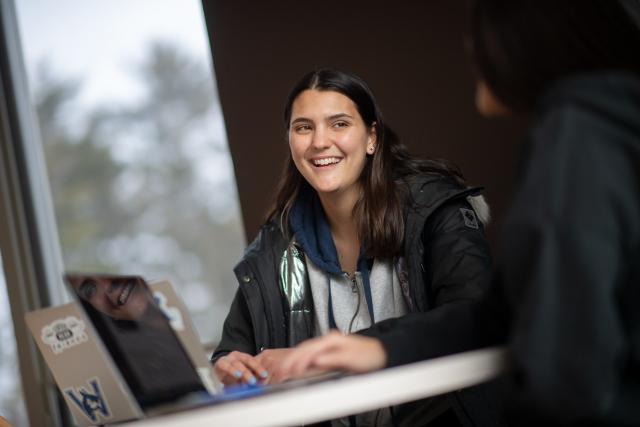 A Westfield State student in conversation with another student