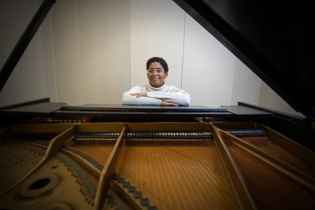 Photo of Westfield State student Aaliyah Brown seated at a piano