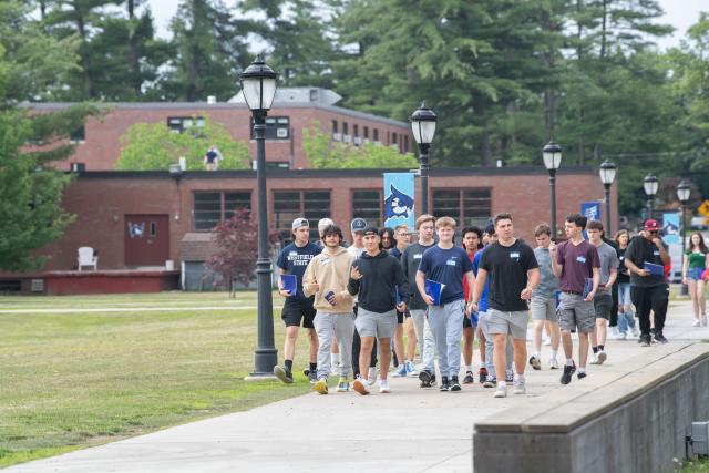 Group of students walking on campus during new student orientation.