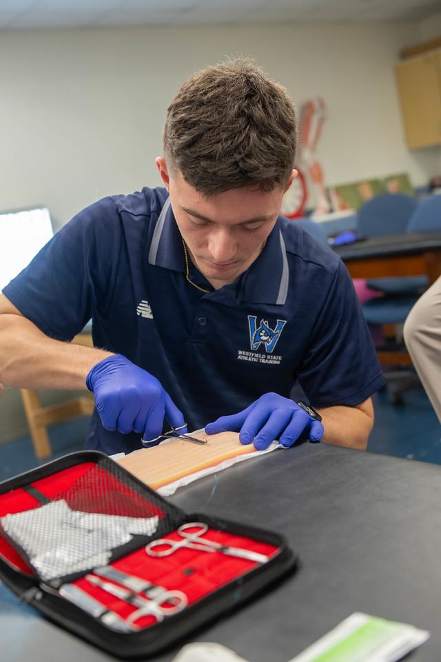 Student working on a hands-on activity in an athletic training class.