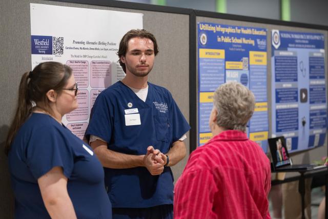 Nursing student speaking with a faculty member at CURCA.