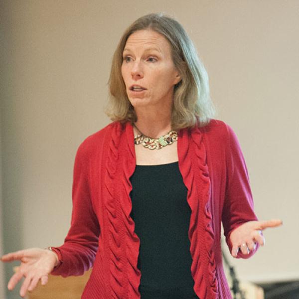 Dr. Kimberly Sherman, Ph.D., Chair of the Management and Marketing Department, stands in a classroom while teaching.