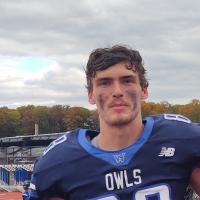 Will Brewster, a junior and football player at Westfield State. He's wearing his Owls uniform and has dark paint smudged on his face from a recent game.