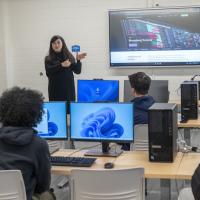 The new Finance & Data Analytics Lab in Parenzo Hall at Westfield State University, Jan 2025. A professor presents during class in front of a television while students watch and listen.